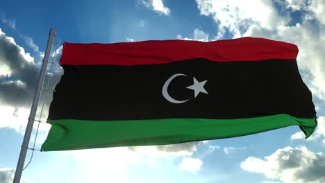 libya national flag waving in the wind, blue sky background