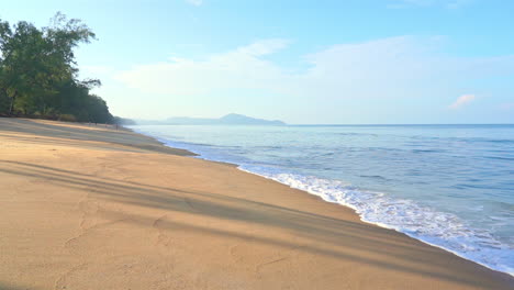 slow motion of exotic sea waves breaking on a hidden empty sandy tropical beach