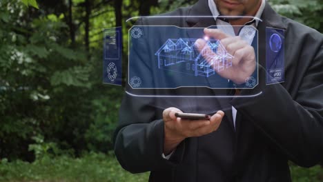 businessman uses hologram with house