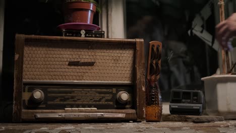 a man collects old things in a box to move from his old house. he leaves his old apartment and is sad