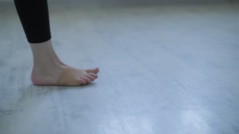 young ballerina practicing dance moves in studio