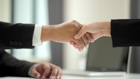 close up two business partner shaking hands successful business deal in modern office. successful business partnership agreement.