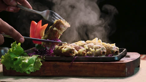 close-up roasted chicken bbq kebab with knife cutting black background