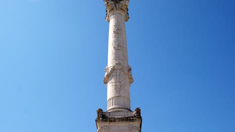 Girondins-monument-with-Angel-of-Liberty-sculpture-in-Bordeaux-France-empty-due-to-the-COVID-19-pandemic,-Tilt-down-reveal-shot