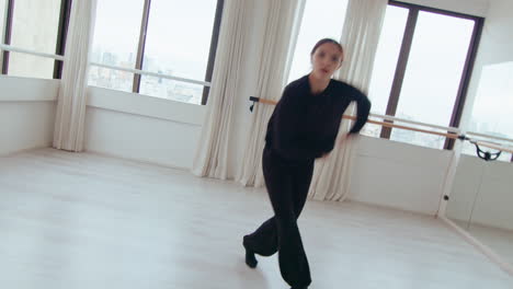 talented female dancer performing contemporary dance and approaching camera