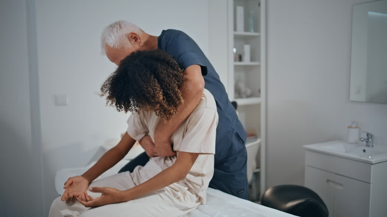 Chiropractor examine woman problem in clinic ward. Therapist doing recovery
