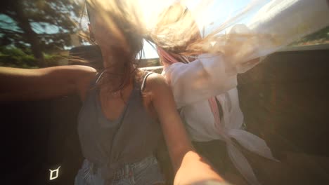 friends enjoying a sunny road trip selfie in a car