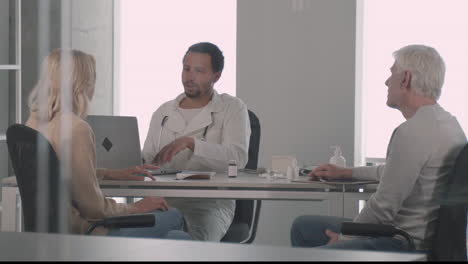 a young black doctor in a medical consultation with a ederly couple 5