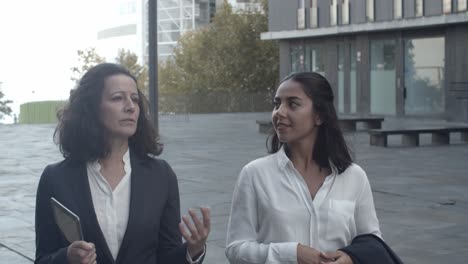 Confident-businesswomen-going-at-work-and-talking