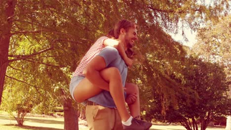 Handsome-man-doing-piggy-back-to-his-girlfriend-