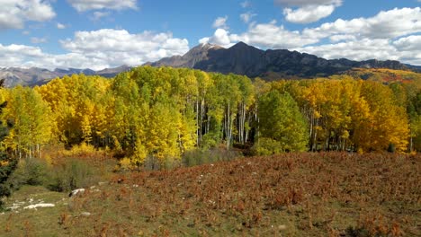 drone flying towards ruby peak colorado mountain during the fall season