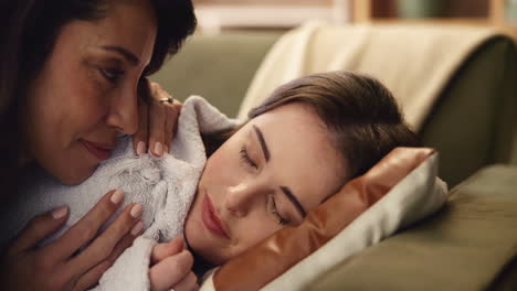 mother and daughter sleeping on couch