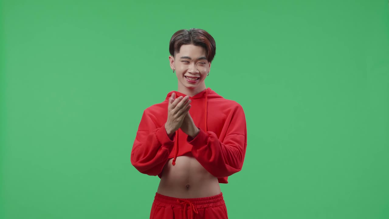 Young Asian Transgender Male Clapping Her Hands And Emotionally Flipping Something In The Green Screen Studio