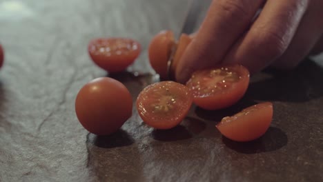 slicing cherry tomatoes on slate