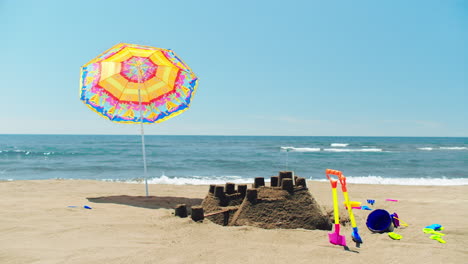 beach day with sandcastle and umbrella