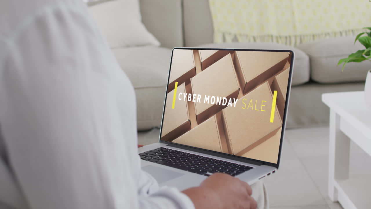 mujer biracial usando una computadora portátil en casa para comprar en línea, cámara lenta