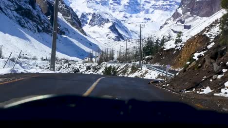 Driving-under-giant-mountains,-Cajón-del-Maipo,-Chile