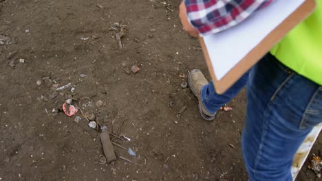 male worker walking with clipboard in the junkyard 4k