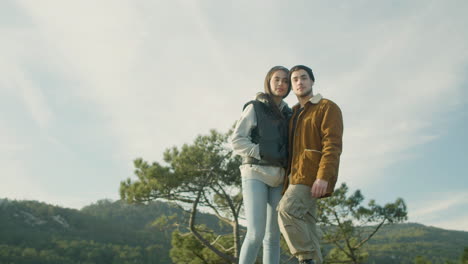 attractive young couple standing on the hill