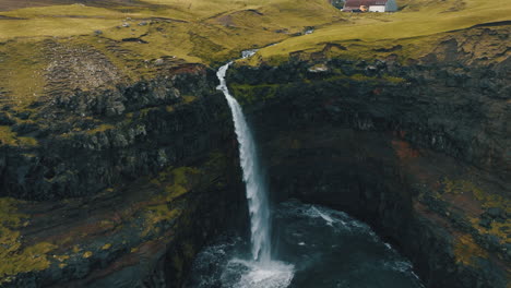 mulafossur waterfall, faroe islands: fantastic aerial view over the famous waterfall in a spectacular setting