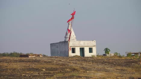 religious flag waving at a hindu temple in rural india