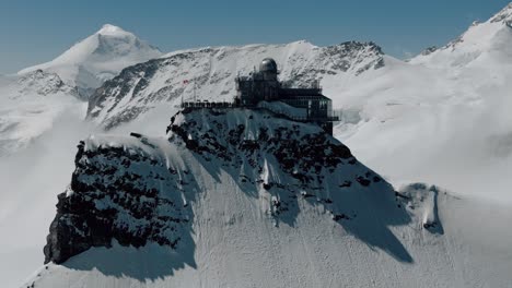 stunning aerial view of a mountaintop observatory in the swiss alps