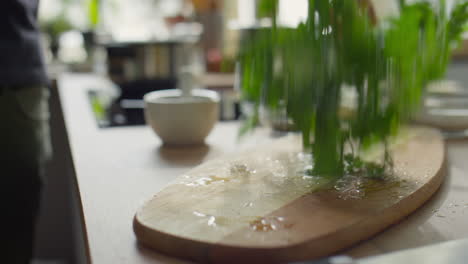 putting fresh parsley on cutting board