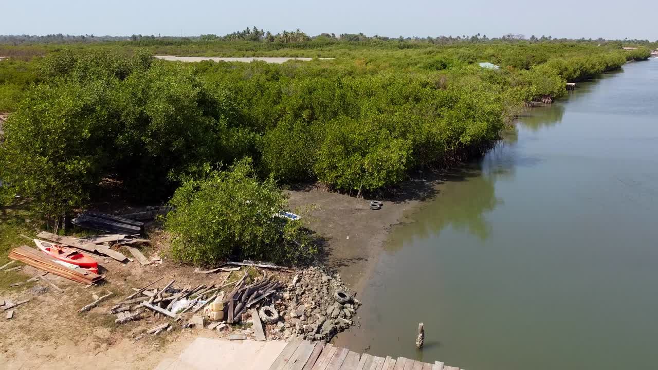 Aerial Drone Fly Above Boats Docked in Bank River Gambia at Stala Adventures, Kartong, West African Landscape during Summer Daylight