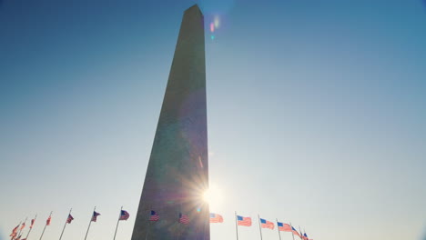 sun appears behind washington monument