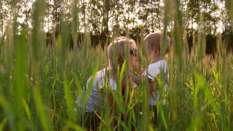 loving mother and son in the field to communicate and hug, the sun's rays illuminate the hair. happy family