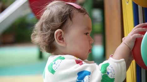 Multi-ethnic-Baby-Girl-Playing-In-The-Playground