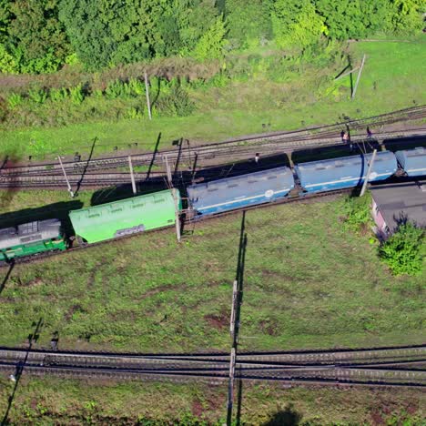 aerial view of a freight train passing through a rural landscape