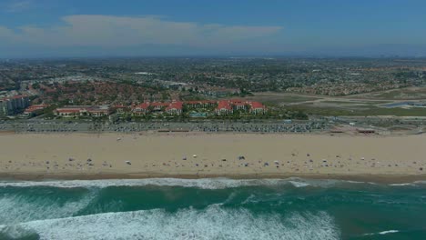 drone flying away from a huntington beach