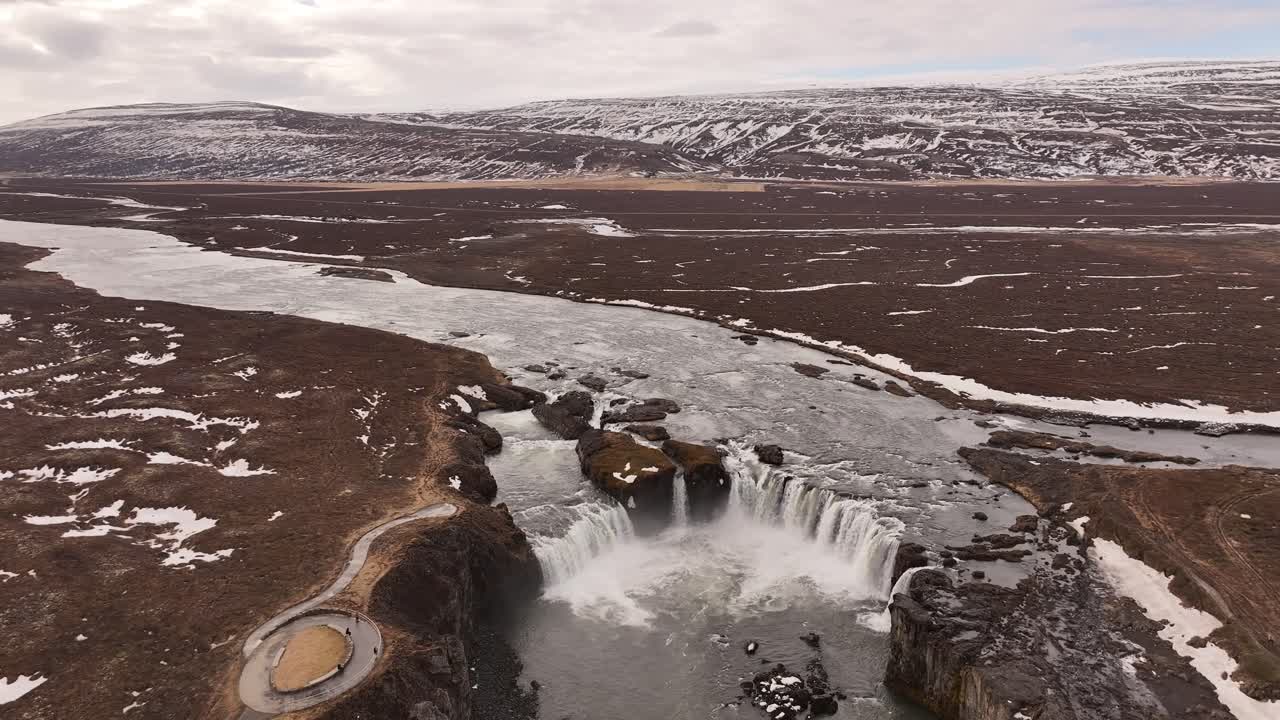 Wide Aerial Circling Shot of Goðafoss Waterfall During Grey Cold Overcast Day in Iceland