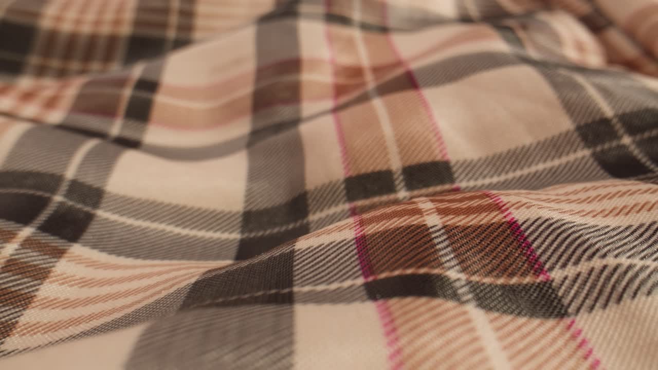 Close-up of Plaid Fabric with Brown, Black, White, and Pink Checkered Pattern