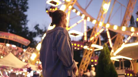 Low-Angle-View-Of-A-Gorgeous-Young-Couple-In-Amusement-Park-At-Night
