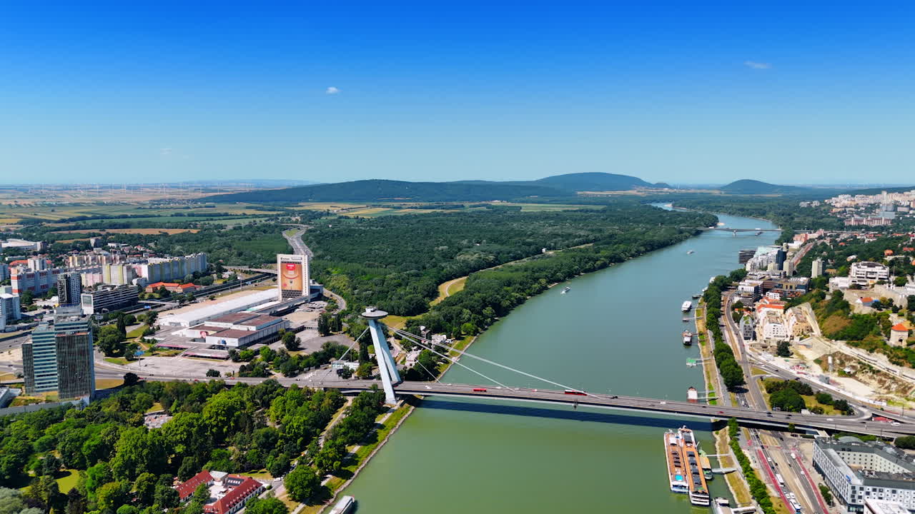 Bratislava by the danube. A beautiful aerial view of Bratislava showcases the Danube River, cityscape, and lush greenery in Europe