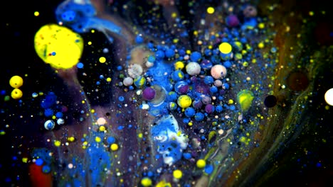 abstract colorful acrylic and food paint bubbles on water