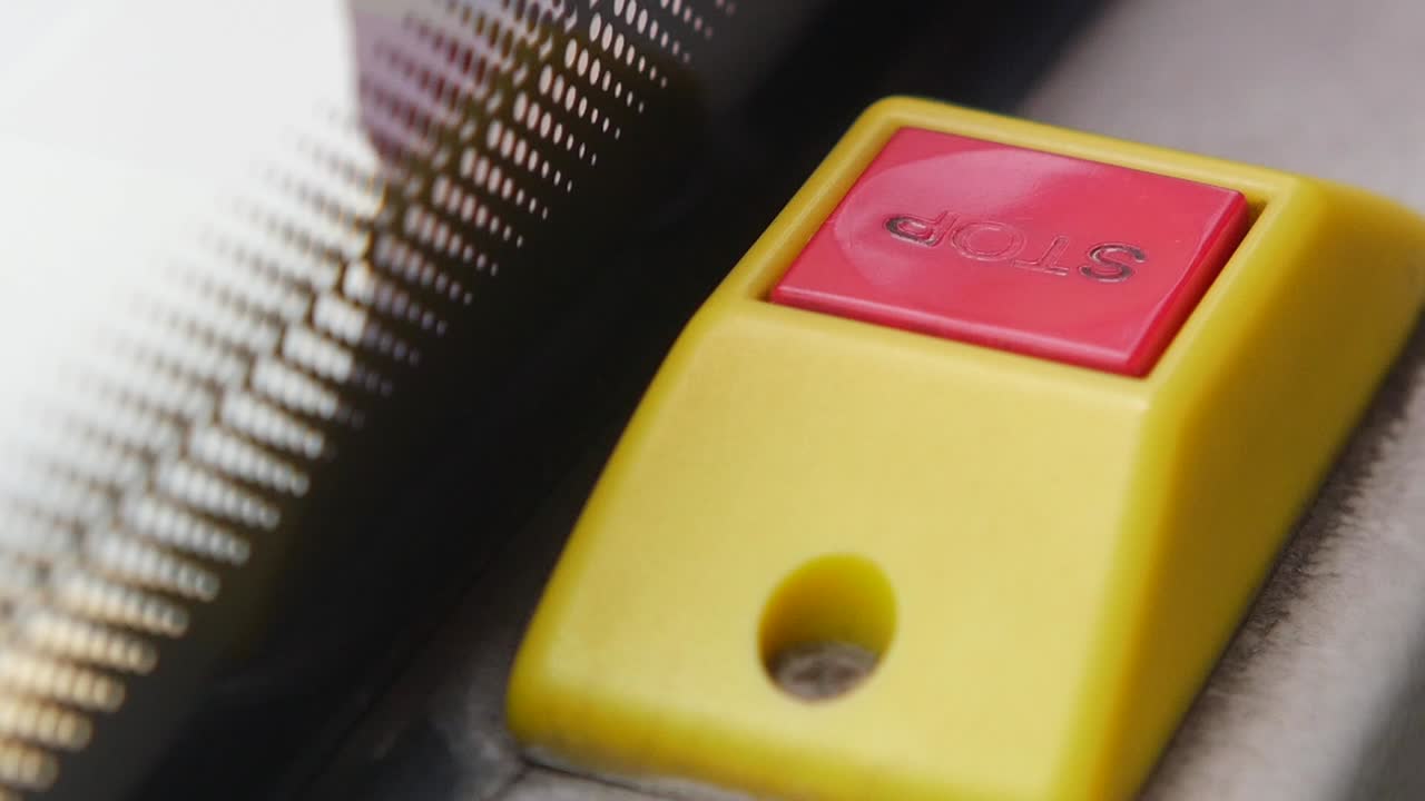 Person Pressing Emergency Stop Button on Machinery
