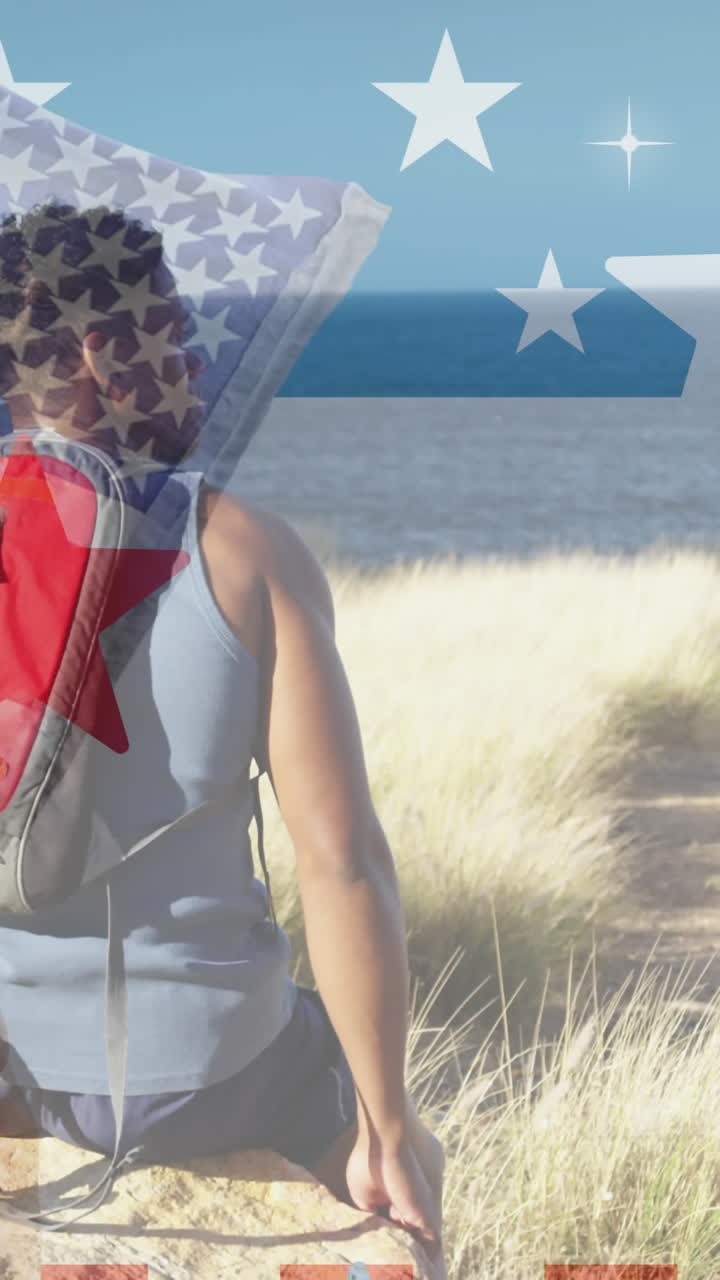 animación de la bandera estadounidense sobre un hombre afroamericano sentado en las montañas