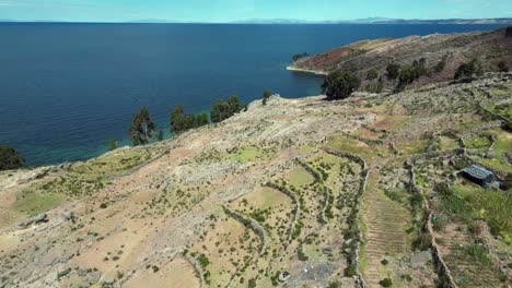 flyover arid terraced hillside of taquile island in lake titicaca peru