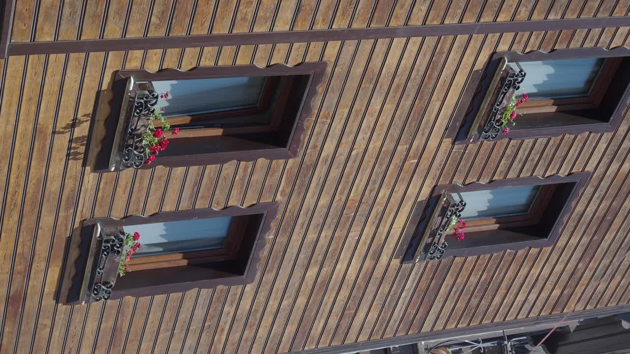 Wooden Facade with Windows and Flower Boxes