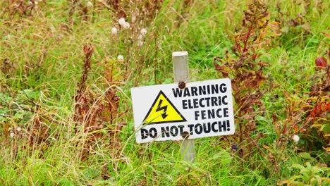 warning sign placed in the ground to let people know the danger posed by the electric fence