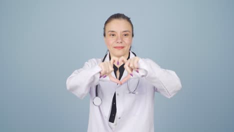 doctor making heart looking at camera.