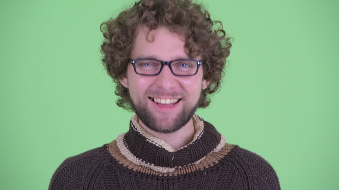 Young handsome bearded man with curly hair