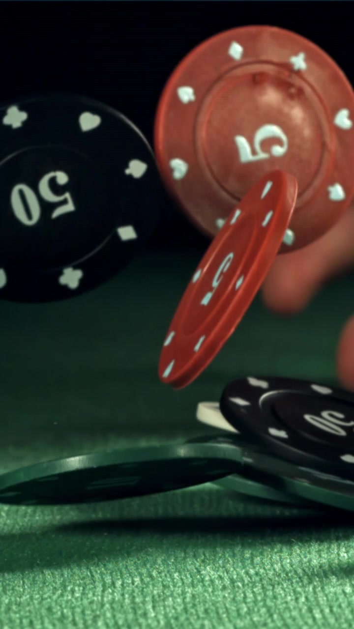 Fiches da poker che cadono al rallentatore su un tavolo da casinò verde