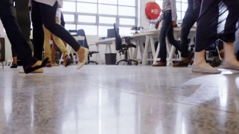 low-section of business executives walking in office