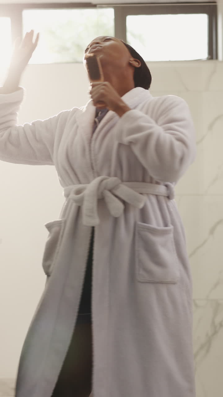 Happy Young Woman Singing and Dancing in Bathroom During Morning Routine