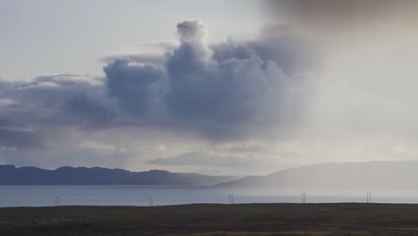 stormy clouds whirl above the fjord. timelapse video