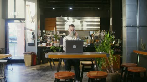 woman working on laptop in a modern cafe